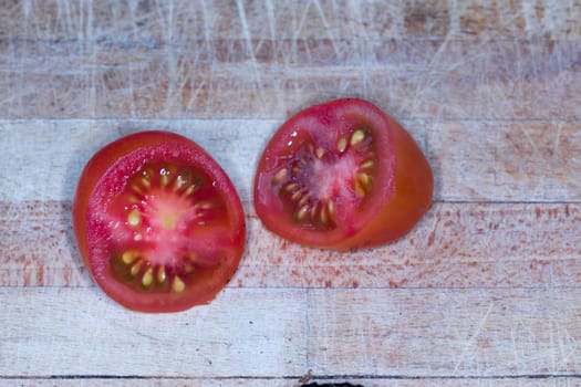 Tomato and black truffle isolated on a wooden cutting board
