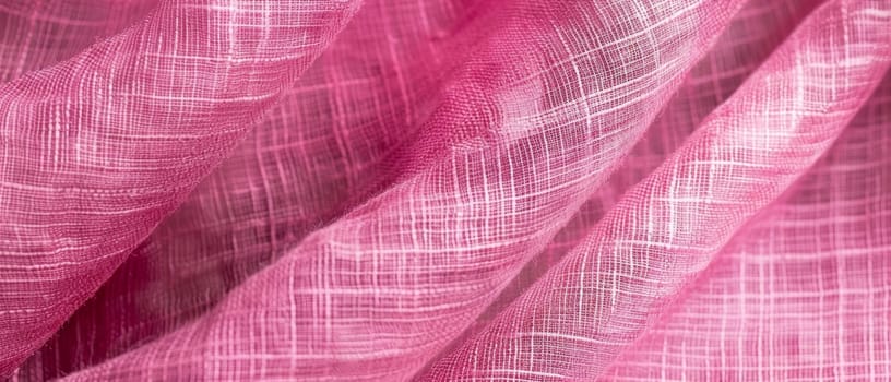 A vibrant pink textile with a distinctive texture, the folds catching the light to enhance the color's intensity