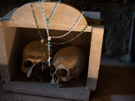 Skull and bones in ancient ossuary, Naples