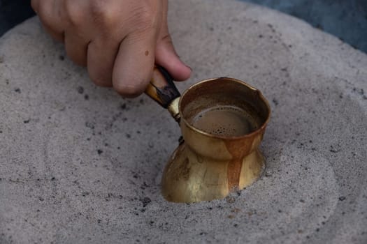 Preparation of desert arabic coffee on hot sand