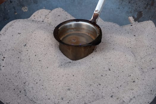 Preparation of desert arabic coffee on hot sand
