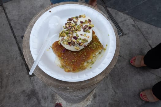 Arabic dessert Kunafa made with cheese and honey and pistache with ice cream