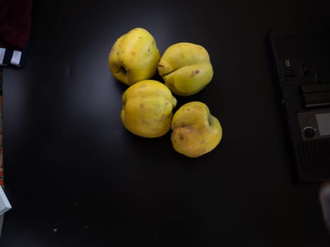 Ingredients for making apple quince jam on black backround