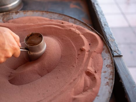 Preparation of desert arabic coffee on hot sand