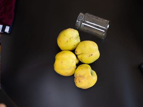 Ingredients for making apple quince jam on black backround