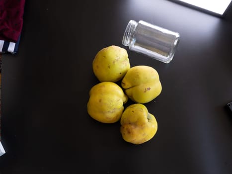 Ingredients for making apple quince jam on black backround