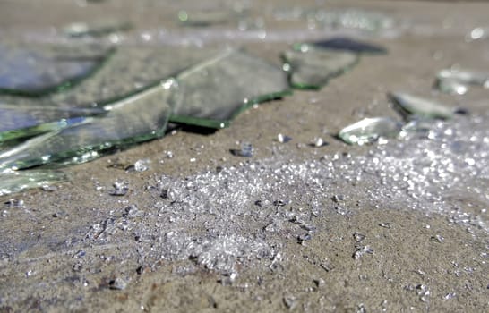 Detail of broken glass thrown in the trash, crime