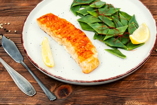 Seared salmon steak with green bean. Space for text.