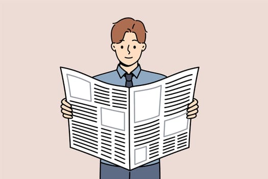 Man reads business newspaper to learn about news from large corporations or looks for job advertisements. Guy with daily newspaper scours press for inside information about company vacancies.
