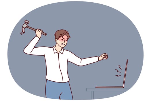Aggressive man smashes laptop screen with hammer because of intrusive ads that interfere with surfing Internet. Guy breaks computer after software crashes or bad e-mail message