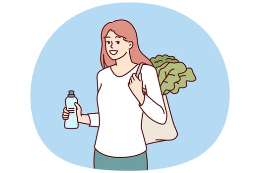 Woman with reusable eco shopping bag and recycled plastic bottle returns from farmer vegetable market. Girl takes care of environment by refusing to use plastic packaging that pollutes nature
