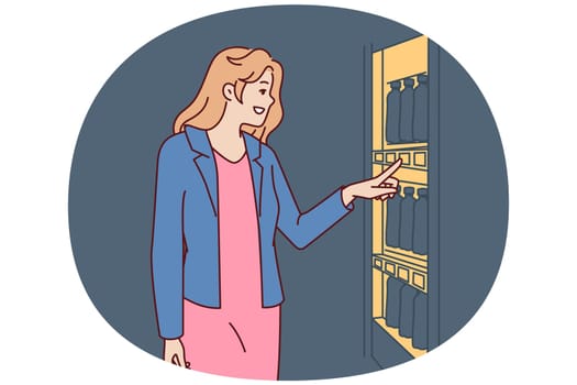 Woman stands near vending machine choosing snack or drink to buy and satisfy hunger and thirst. Young happy girl wishes to buy soda or sandwich in vending machine or automated store