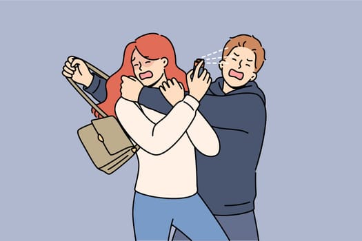 Man robber sprayed with gas from victim spray bottle, using pepper spray for self-defense. Girl trying to save woman from robber who is stealing handbag with purse for purpose of dishonest enrichment.