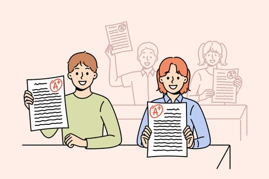 Smart schoolchildren demonstrate excellent exam test results, sitting at desks in classroom. Schoolchildren receive education in primary school and rejoice at good grade from teacher