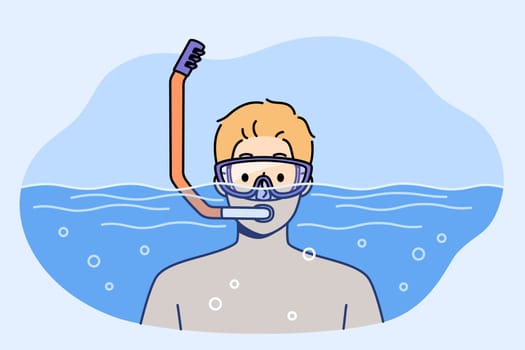 Man swims in pool with goggles and snorkel for breathing underwater during summer holiday at sunny resort. Guy visiting pool is engaged in active recreation and enjoys diving in free time from work.
