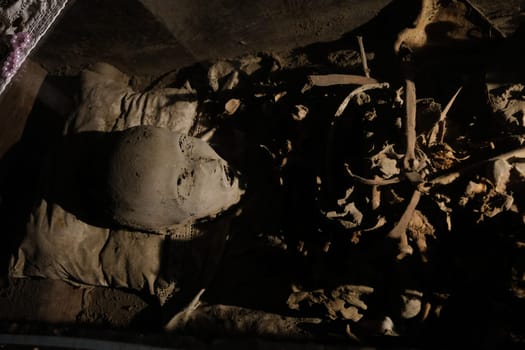 Skull and bones in ancient ossuary, Naples