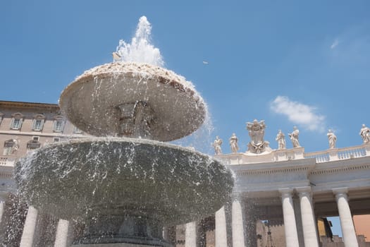 Fountain in Rome with the background of St. Peter's Basilica