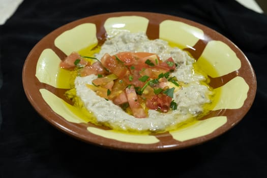 Hummus , sauce made from chickpea paste and sesame seed paste flavored with olive oil, garlic, lemon and paprika juice, cumin seed powder and finely chopped parsley.