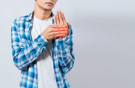 People with arthritis and hand pain, Young suffering person with pain in hand joints. Man with pain in hands with copy space. Man with arthritis rubbing his hands