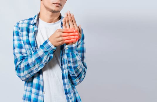 People with arthritis and hand pain, Young suffering person with pain in hand joints. Man with pain in hands with copy space. Man with arthritis rubbing his hands