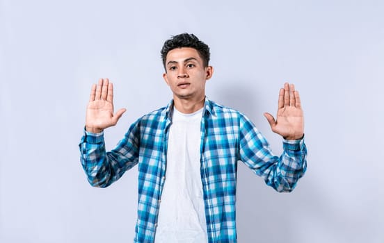 Scared and horrified man with raised palms, Man with a frightened face with his hands raised in front. Portrait of scared person with raised hands, Scared guy with raised hands in front