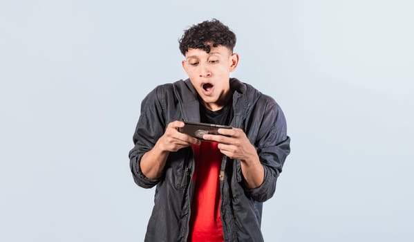 Man amazed holding cell phone horizontally, Guy gasping and playing games on his smartphone