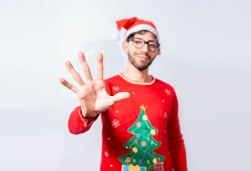 Man in christmas hat counting number five with fingers. Man in christmas costume counting number five with fingers. Concept of man in christmas costume counting number five isolated