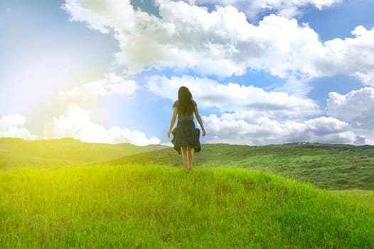woman in the field spreading her hands, concept of woman in the field in freedom