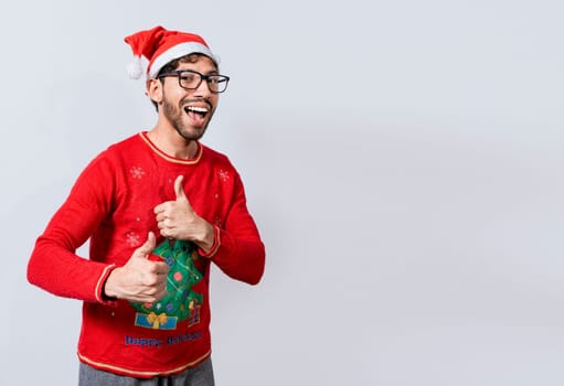 Happy young man in christmas hat giving thumbs up. People in santa hat doing ok gesture. Concept of christmas man giving thumbs up, Smiling guy in christmas hat with thumbs up