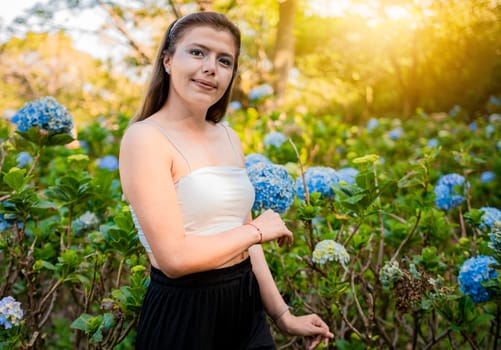 Portrait of young woman in a hydrangea field. Woman in a hydrangea garden, Beautiful girl in a natural flower nursery. El Crucero - Managua, Nicaragua