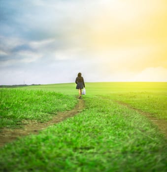 woman walking in the field with shopping bags, woman walking on a road in the field
