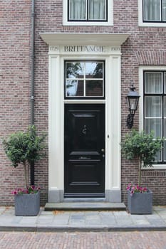 an old, beautifully decorated front door black and white