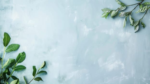 Lush green leaves stand out against a soft light blue backdrop, creating a striking contrast. The leaves are vibrant and healthy, with intricate veins on display.