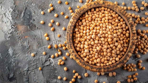 A ceramic bowl filled with chickpeas placed on top of a wooden table surface. The chickpeas are neatly arranged in the bowl, creating a visually appealing display.