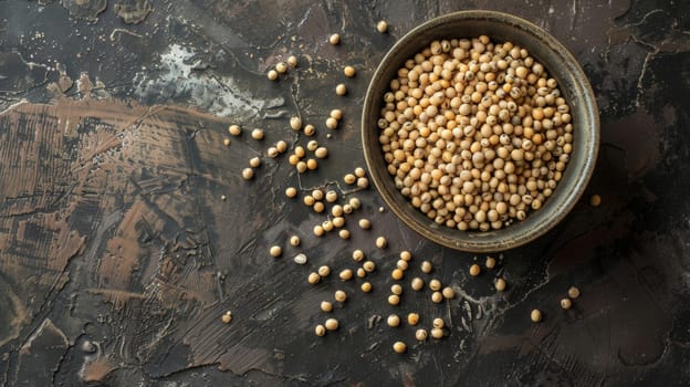 A ceramic bowl filled to the brim with chickpeas sits on top of a wooden table, with the light delicately illuminating the texture of the legumes. The tables surface is smooth, showcasing the contrast of the rough chickpeas against it.