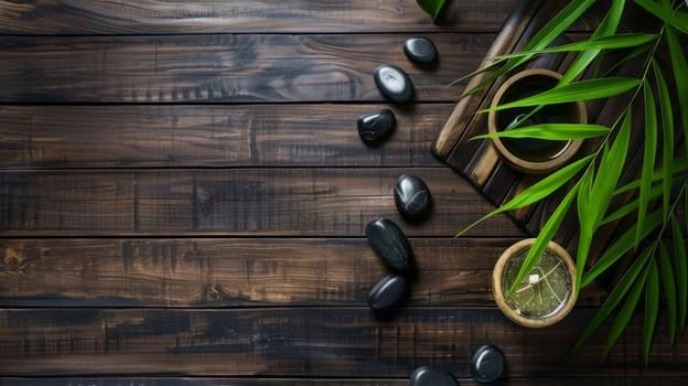 A wooden table is displayed with black stones neatly arranged on top. Among the stones sits a vibrant green plant, adding a pop of color to the composition.