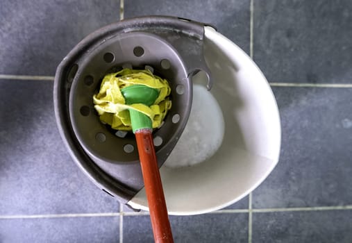 Detail of mop with water to clean the floor