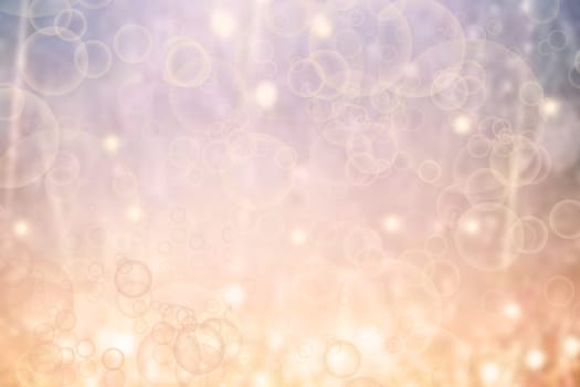 A festive abstract delicate Happy New Year or Christmas background texture with colorful gold yellow pink blurred bokeh lights and stars. Space for design. Card concept or advertising.