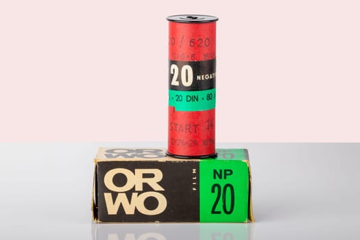 Potsdam, Germany - Aug 11, 2018. A old ORWO (Original Wolfen) NP20 (NP= Negative Panchromatic) film roll and its packaging on table over light background. Analogue vintage photography.