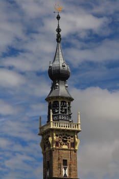a beautiful steeple, with blue sky in the background