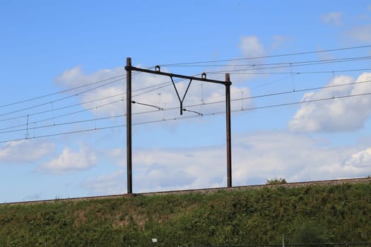 Embankment with catenary, blue sky in the background