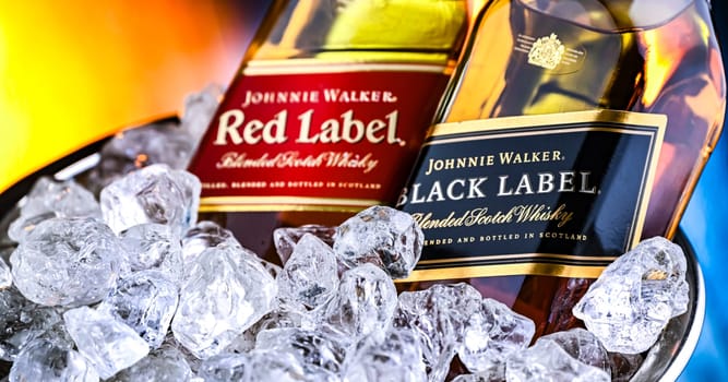 POZNAN, POL - FEB 28, 2024: Bottles of Johnnie Walker, the most widely distributed brand of blended Scotch whisky in the world with sales of over 130 million bottles a year.