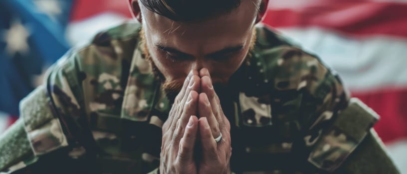 An intimate portrait of a soldier in prayerful contemplation, with the American flag in the background