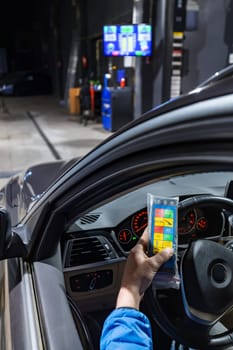 Get a glimpse of automotive expertise as a mechanic inside a car, operating a brake test equipment, ensuring precise testing of brake pads on the brake testing machine in the service center.