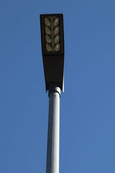 A rectangular street lamp, blue sky in the background