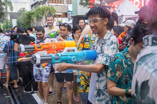 Siam Square, Bangkok, Thailand - APR 13, 2024 Songkran Festival, The short action of people joins celebrations of the Thai New Year or Songkran in Siam Square Bangkok, Thailand.