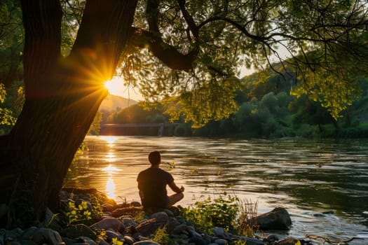 Peaceful image of a person meditating by a riverbank at sunset with trees in the background