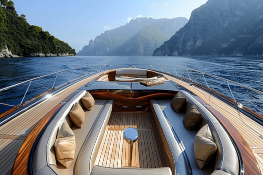Scenic view from the bow of a deluxe yacht cruising by stunning mountains on a sunny day