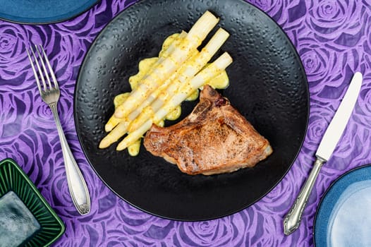 Roasted meat steak with boiled white asparagus. Healthy dinner.