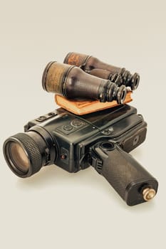 Nostalgic items from film to flight, and leather notes, against white, evoking a sense of adventurous holidays and charming mysteries